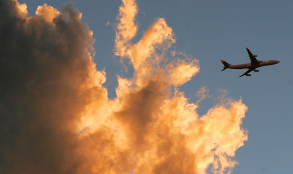 Jet plane in the sky with dramatic clouds